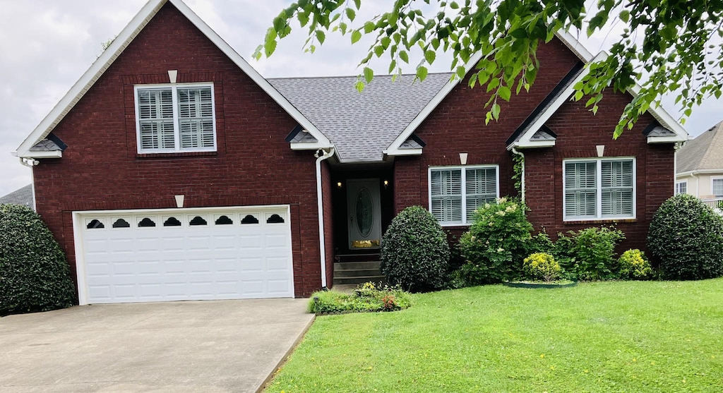 104 Brookview Ct, Springfield, TN 37172 - view of front of home featuring brick siding, a front lawn, driveway, and a shingled roof