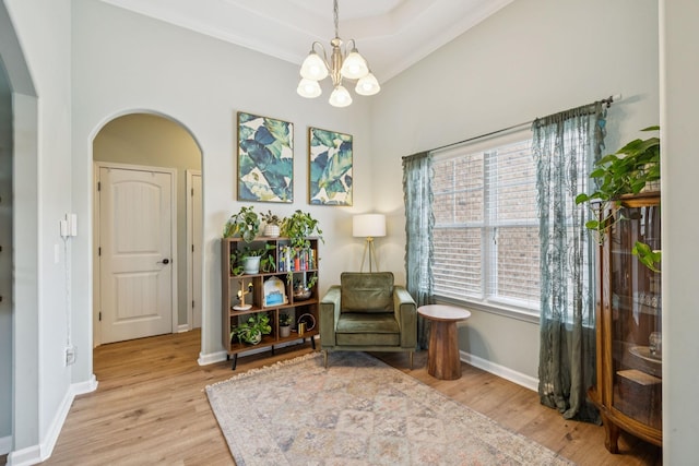 3022 Honeysuckle Dr, Spring Hill, TN 37174 - living area with arched walkways, light wood-type flooring, a chandelier, and ornamental molding