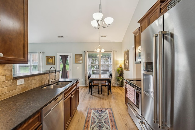 3022 Honeysuckle Dr, Spring Hill, TN 37174 - kitchen featuring stainless steel appliances, a chandelier, backsplash, light wood finished floors, and plenty of natural light