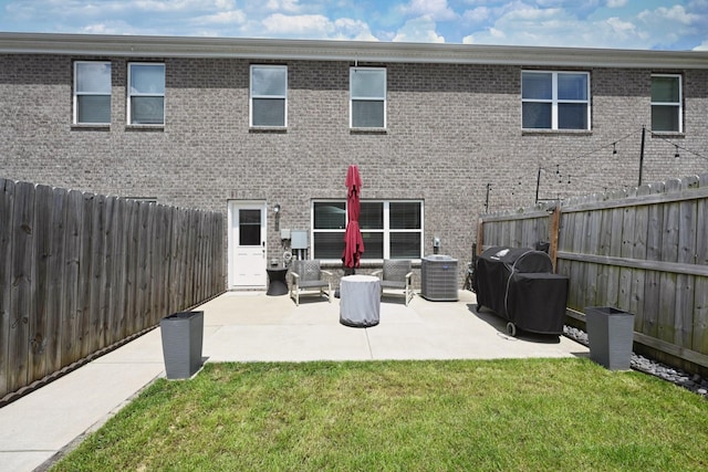 2004 Hardwick Ln, Gallatin, TN 37066 - rear view of house with a fenced backyard, a patio area, and brick siding