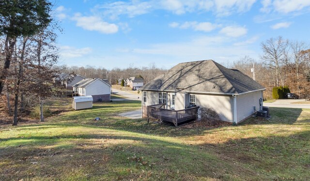 2276 Yeager Dr, Clarksville, TN 37040 - view of home's exterior featuring a lawn, a deck, and roof with shingles
