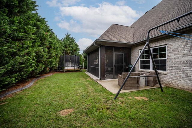 1241 Hensfield Dr, Murfreesboro, TN 37128 - view of grassy yard featuring a trampoline, a sunroom, and a patio area