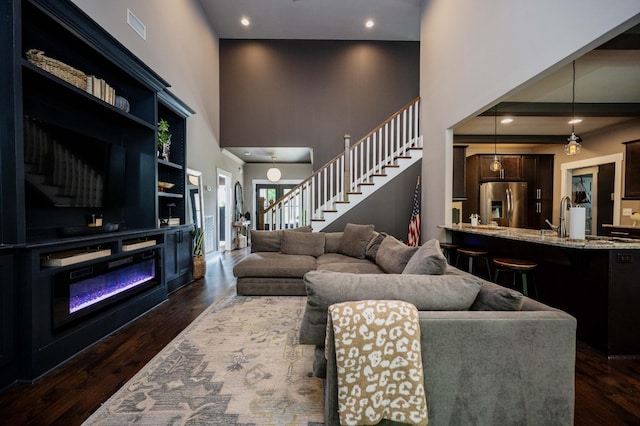 1241 Hensfield Dr, Murfreesboro, TN 37128 - living area with stairway, a high ceiling, dark wood-type flooring, and recessed lighting