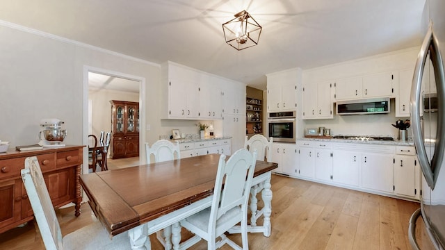 400 Westland Dr, Lebanon, TN 37087 - dining room with light wood finished floors, crown molding, and a chandelier