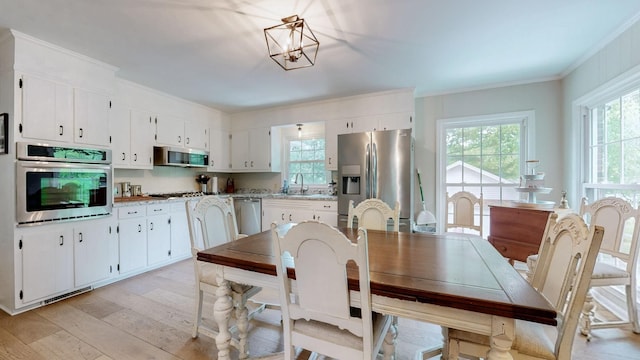 400 Westland Dr, Lebanon, TN 37087 - dining room featuring crown molding, light wood-type flooring, and a chandelier