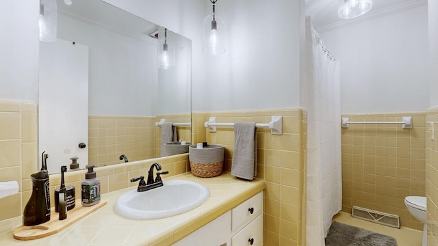 400 Westland Dr, Lebanon, TN 37087 - bathroom featuring tile walls, vanity, ornamental molding, a wainscoted wall, and a shower with curtain