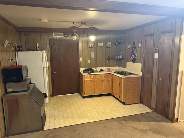 2503 Hickory Dr, Springfield, TN 37172 - kitchen featuring black microwave, wood walls, light countertops, light carpet, and freestanding refrigerator