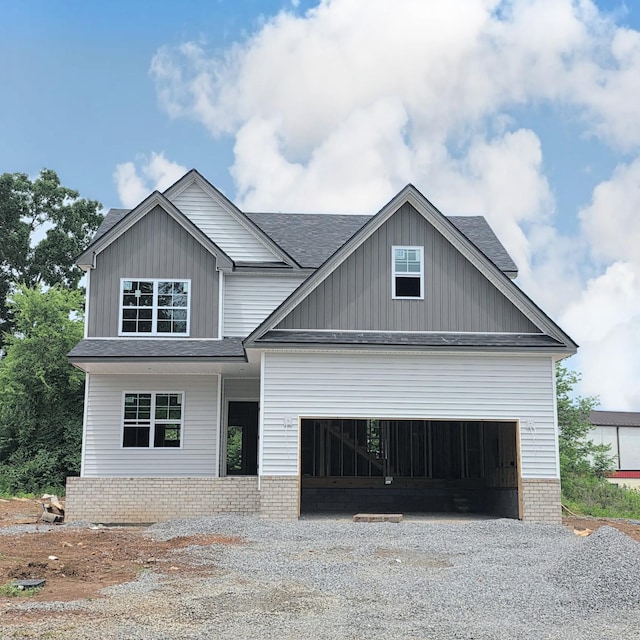 373 Wesson Dr, Clarksville, TN 37043 - craftsman house with brick siding, gravel driveway, roof with shingles, a garage, and board and batten siding