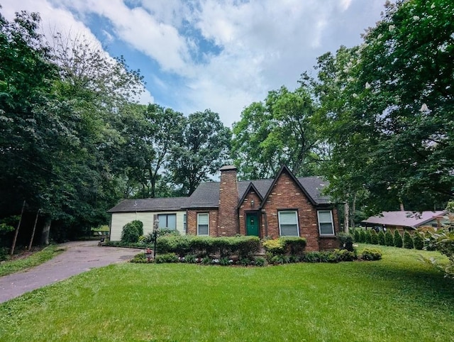 4603 Log Cabin Rd, Nashville, TN 37216 - view of front of home with a chimney, a front lawn, brick siding, and driveway