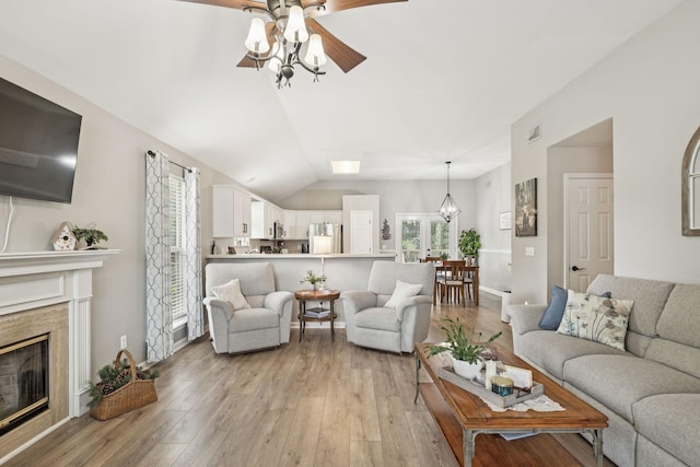 4012 Amber Way, Spring Hill, TN 37174 - living room with ceiling fan, light wood-style floors, a high end fireplace, lofted ceiling, and a chandelier