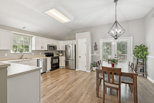 4012 Amber Way, Spring Hill, TN 37174 - kitchen with appliances with stainless steel finishes, light countertops, light wood finished floors, a chandelier, and white cabinets