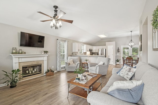 4012 Amber Way, Spring Hill, TN 37174 - living area featuring plenty of natural light, lofted ceiling, light wood-type flooring, a chandelier, and a ceiling fan