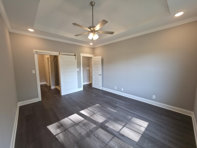 280 Turkey Crossing Ct, Clarksville, TN 37043 - unfurnished bedroom with a tray ceiling, a barn door, dark wood-style floors, recessed lighting, and ornamental molding