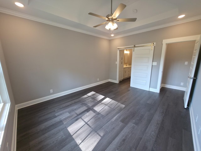 280 Turkey Crossing Ct, Clarksville, TN 37043 - unfurnished bedroom featuring crown molding, a barn door, dark wood finished floors, a tray ceiling, and recessed lighting