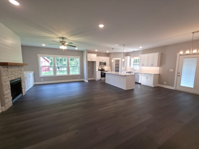 280 Turkey Crossing Ct, Clarksville, TN 37043 - unfurnished living room with a ceiling fan, a stone fireplace, dark wood-type flooring, and recessed lighting