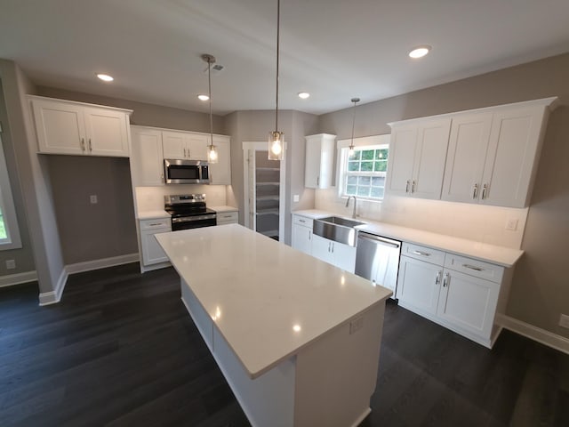 280 Turkey Crossing Ct, Clarksville, TN 37043 - kitchen featuring stainless steel appliances, dark wood-style floors, white cabinets, a kitchen island, and recessed lighting