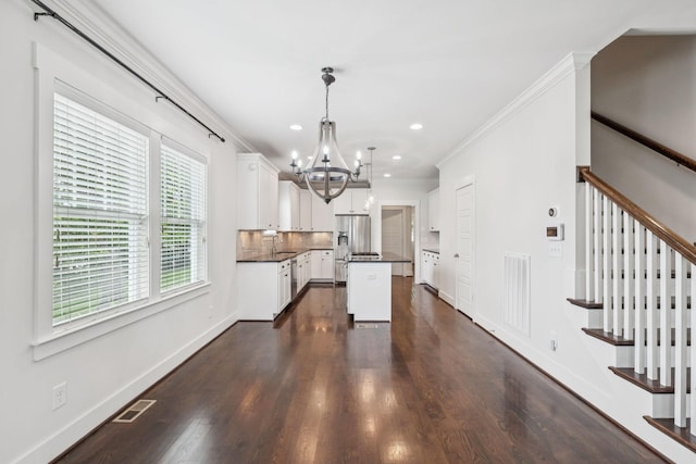4704B Michigan Ave, Nashville, TN 37209 - kitchen with a chandelier, stainless steel fridge, dark countertops, a kitchen island, and white cabinetry