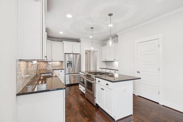 4704B Michigan Ave, Nashville, TN 37209 - kitchen featuring appliances with stainless steel finishes, ornamental molding, a center island, decorative backsplash, and dark stone countertops