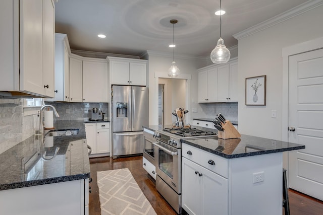 4704B Michigan Ave, Nashville, TN 37209 - kitchen featuring stainless steel appliances, ornamental molding, a kitchen island, white cabinetry, and backsplash
