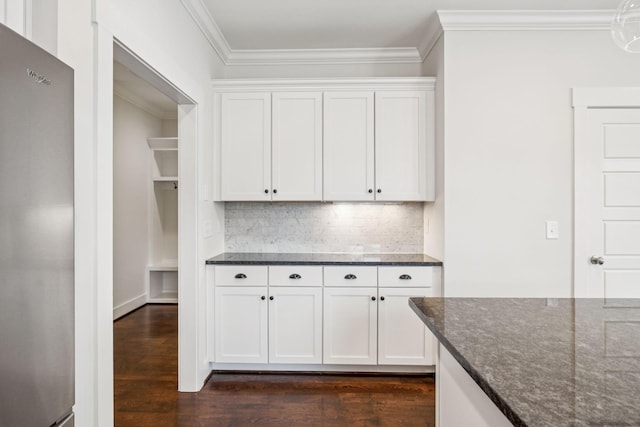 4704B Michigan Ave, Nashville, TN 37209 - kitchen with freestanding refrigerator, dark wood-style floors, dark stone counters, white cabinets, and crown molding
