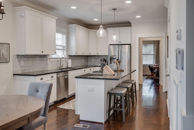4704B Michigan Ave, Nashville, TN 37209 - kitchen featuring appliances with stainless steel finishes, healthy amount of natural light, white cabinetry, crown molding, and recessed lighting