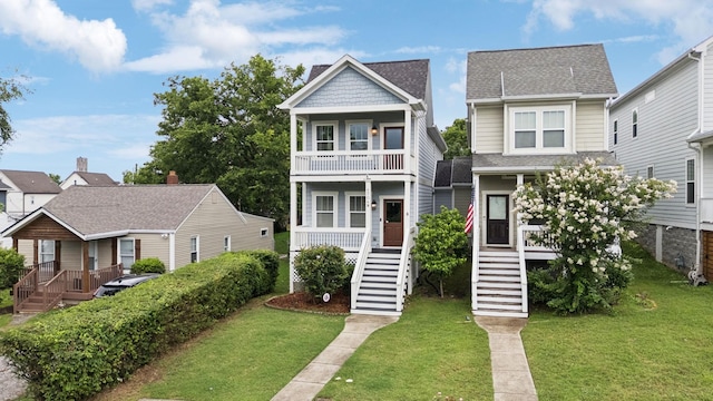 4704B Michigan Ave, Nashville, TN 37209 - view of front of home with stairs, a balcony, a front yard, covered porch, and a shingled roof