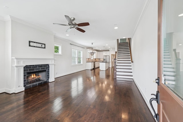 4704B Michigan Ave, Nashville, TN 37209 - unfurnished living room featuring stairs, crown molding, ceiling fan, dark wood finished floors, and a tile fireplace