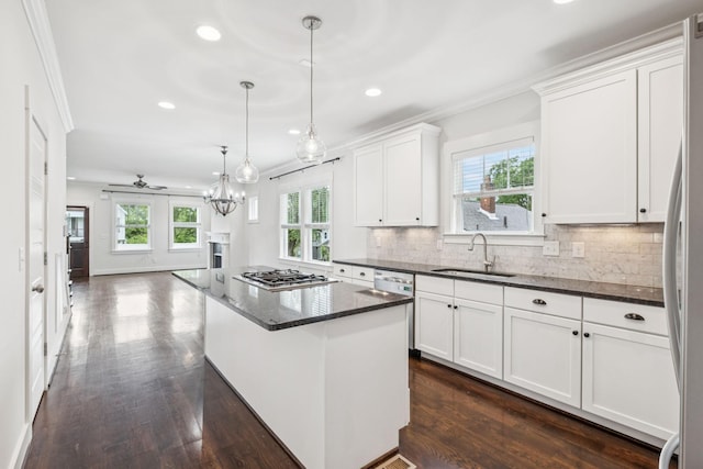 4704B Michigan Ave, Nashville, TN 37209 - kitchen featuring appliances with stainless steel finishes, ornamental molding, recessed lighting, dark wood-style floors, and white cabinets