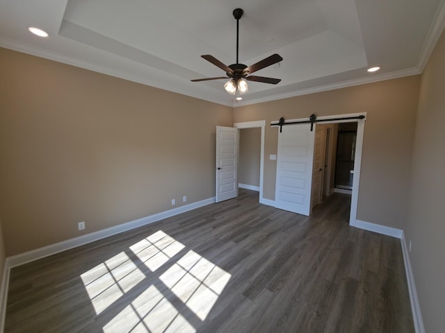 286 Turkey Crossing Ct, Clarksville, TN 37043 - unfurnished bedroom with a raised ceiling, dark wood-style floors, recessed lighting, crown molding, and a barn door