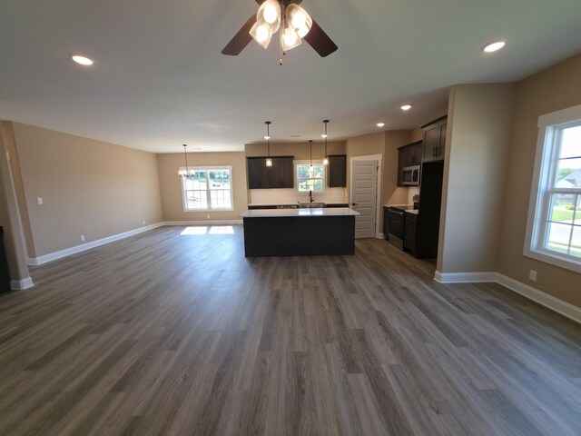 286 Turkey Crossing Ct, Clarksville, TN 37043 - unfurnished living room with plenty of natural light, recessed lighting, dark wood-style flooring, ceiling fan, and a chandelier