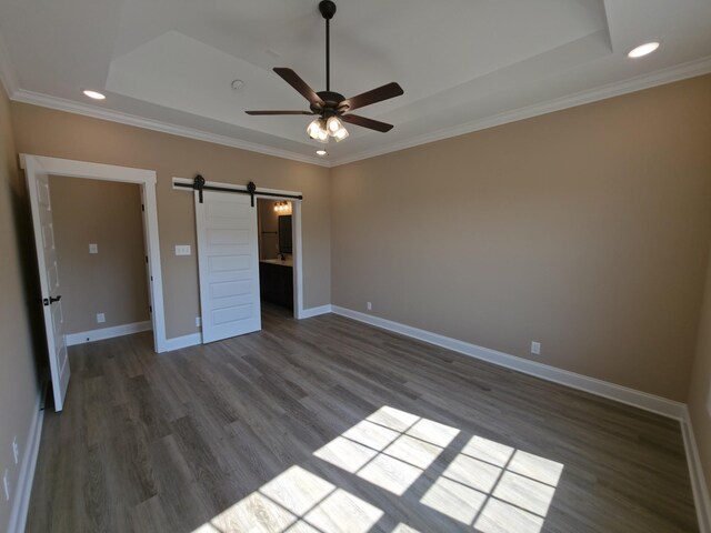 286 Turkey Crossing Ct, Clarksville, TN 37043 - unfurnished bedroom featuring a tray ceiling, dark wood-style flooring, crown molding, a barn door, and recessed lighting