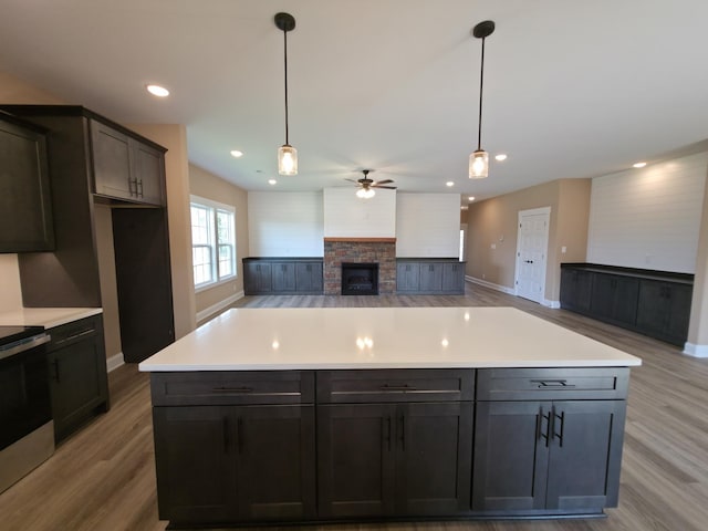286 Turkey Crossing Ct, Clarksville, TN 37043 - kitchen with light wood-style floors, electric range, a fireplace, ceiling fan, and recessed lighting