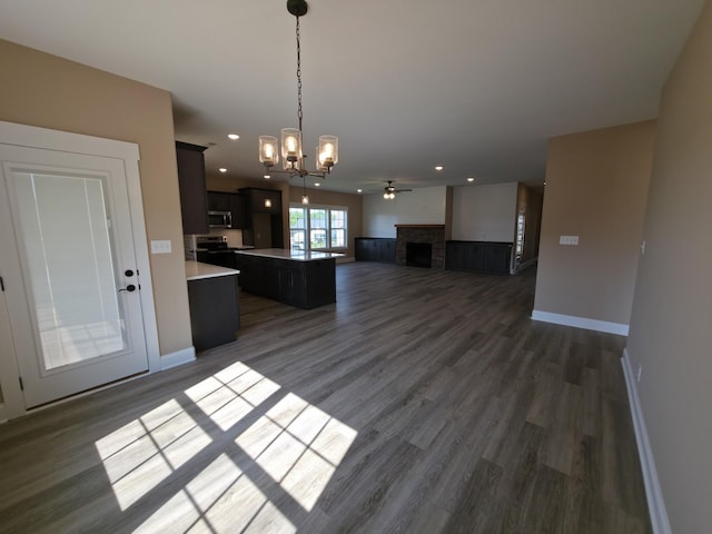 286 Turkey Crossing Ct, Clarksville, TN 37043 - kitchen with open floor plan, stainless steel microwave, dark wood finished floors, a fireplace, and light countertops