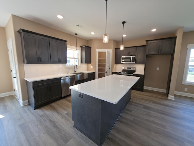 286 Turkey Crossing Ct, Clarksville, TN 37043 - kitchen with stainless steel appliances, a kitchen island, recessed lighting, dark wood-style flooring, and light countertops