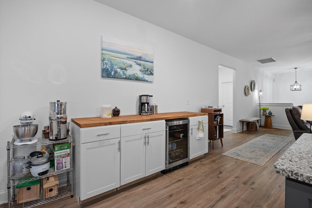 9407 Hackberry Ln, Soddy Daisy, TN 37379 - indoor dry bar featuring beverage cooler, light wood finished floors, and decorative light fixtures