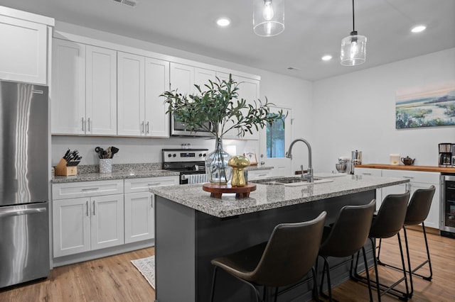 9407 Hackberry Ln, Soddy Daisy, TN 37379 - kitchen featuring appliances with stainless steel finishes, recessed lighting, light stone countertops, and light wood-style floors