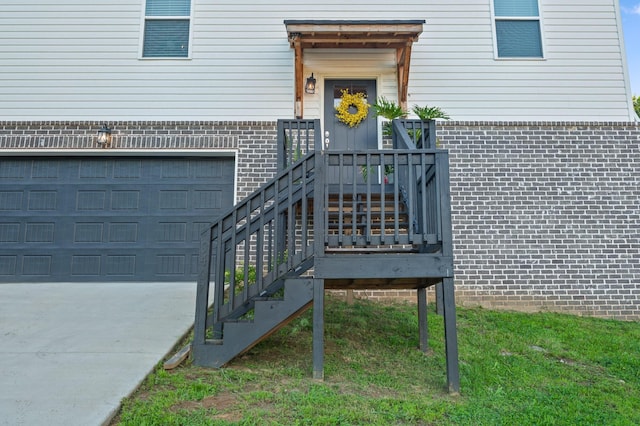 9407 Hackberry Ln, Soddy Daisy, TN 37379 - doorway to property featuring brick siding, a garage, and driveway