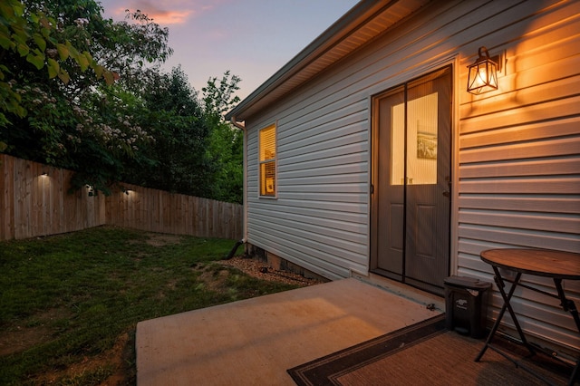 9407 Hackberry Ln, Soddy Daisy, TN 37379 - exterior entry at dusk featuring a patio area