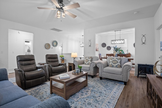 9407 Hackberry Ln, Soddy Daisy, TN 37379 - living area featuring wood finished floors, a ceiling fan, and a chandelier
