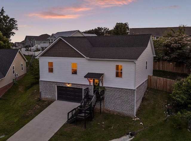9407 Hackberry Ln, Soddy Daisy, TN 37379 - rear view of house with driveway, an attached garage, stairs, and a shingled roof