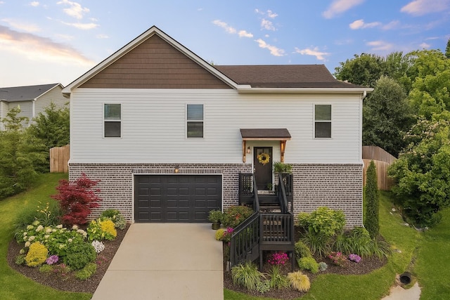 9407 Hackberry Ln, Soddy Daisy, TN 37379 - split foyer home with concrete driveway, brick siding, and an attached garage