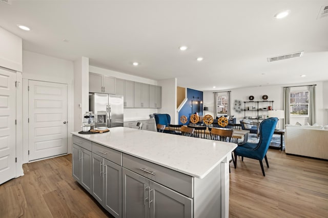582 Gingerwood Ln, Hendersonville, TN 37075 - kitchen featuring stainless steel refrigerator with ice dispenser, gray cabinets, light wood-style floors, a kitchen island, and recessed lighting