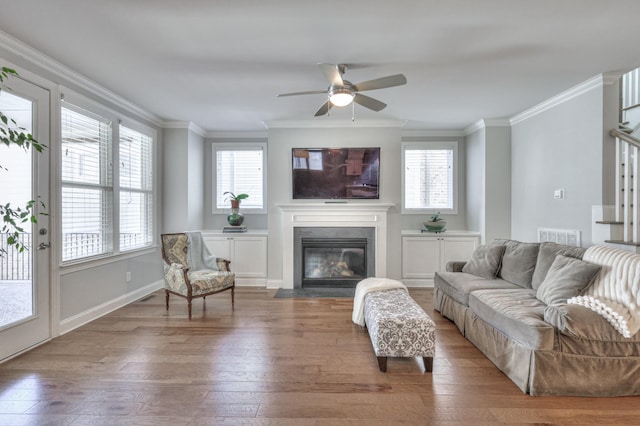 232 Moray Ct, Franklin, TN 37064 - living room featuring ornamental molding, wood-type flooring, a fireplace with flush hearth, ceiling fan, and stairs