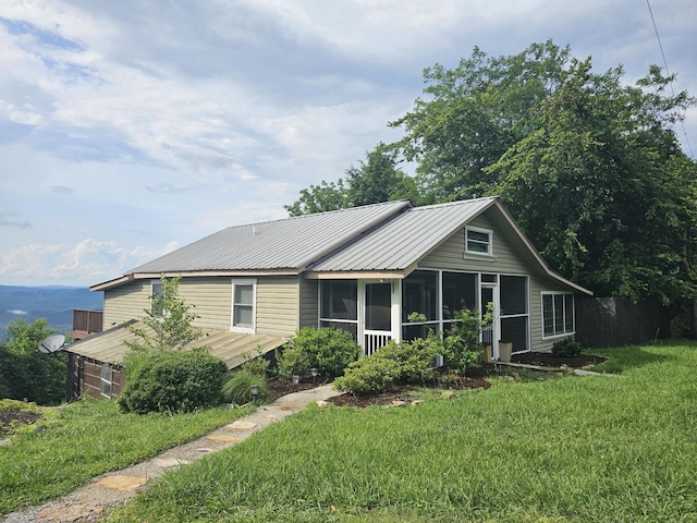 9311 Scenic Hwy, Lookout Mountain, GA 30750 - ranch-style home featuring a sunroom, a front lawn, and a metal roof