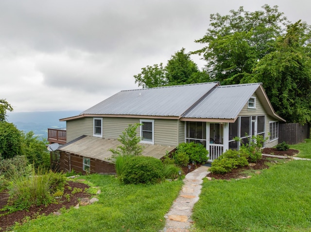 9311 Scenic Hwy, Lookout Mountain, GA 30750 - view of front of house with a sunroom, a front lawn, and a metal roof