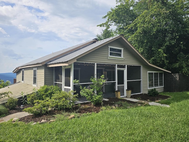 9311 Scenic Hwy, Lookout Mountain, GA 30750 - rear view of property featuring a sunroom, a metal roof, and a lawn