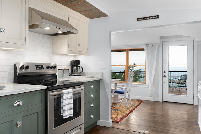 9311 Scenic Hwy, Lookout Mountain, GA 30750 - kitchen with stainless steel electric stove, wall chimney range hood, green cabinets, and decorative backsplash