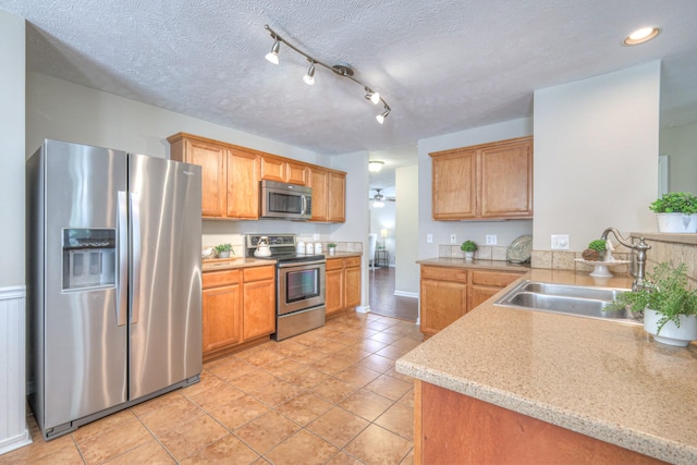 5451 Middlebury Dr, Murfreesboro, TN 37128 - kitchen featuring stainless steel appliances, light tile patterned floors, a textured ceiling, recessed lighting, and brown cabinetry