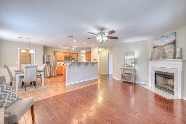 5451 Middlebury Dr, Murfreesboro, TN 37128 - living room featuring ceiling fan, light wood-style flooring, a high end fireplace, and recessed lighting