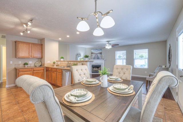5451 Middlebury Dr, Murfreesboro, TN 37128 - dining area with a fireplace, a chandelier, ceiling fan, recessed lighting, and light tile patterned floors